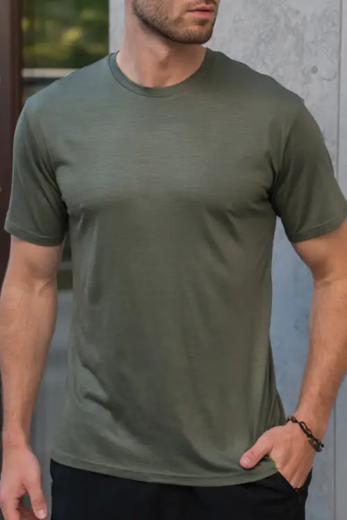 Zbliżenie na dzianinę zielonego t-shirtu merino, widoczna faktura materiału 150 g/m²